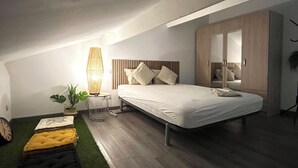 A bedroom with a bed, a bedside table, a lamp, and a wardrobe. - Bobo Chic Paradise (Villeneuve-Loubet)