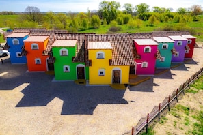 A row of colorful houses with tiled roofs, arranged in a linear fashion. - Comfortable Mexican-style Holiday Home (Ustka)