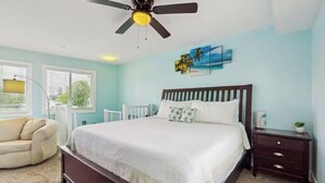 A bedroom with a bed, a ceiling fan, a nightstand, a dresser, and a window with blinds. - 1st floor Condo near Lake MI, Saugatuck and  many attraction's.
Heated pool! (Douglas)