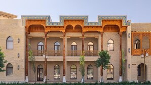 A building with a traditional architectural style, featuring arched windows and wooden balconies.