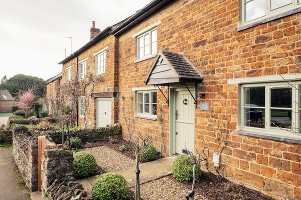 This charming mid-terrace, double-fronted honey-stone cottage is an absolute gem