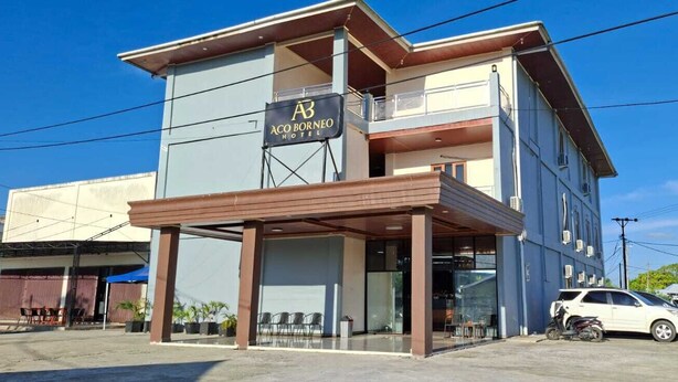 A two-story building with a sign for 'Aco Borneo Hotel' on the front. - ACO BORNEO HOTEL (Malinau)