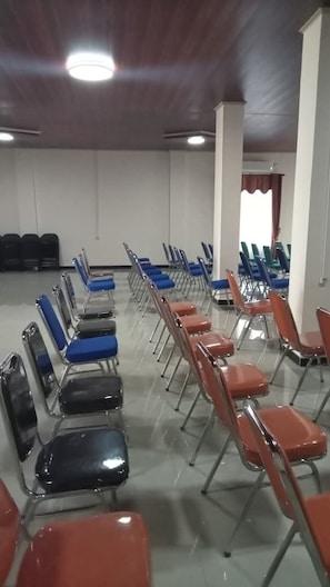 A room with rows of chairs and a white wall. - ACO BORNEO HOTEL (Malinau)