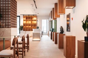 A modern interior with a reception desk, seating area, and decorative elements. - Majestic 2-Bed Pool Access Suite by Bocobay (Willemstad)