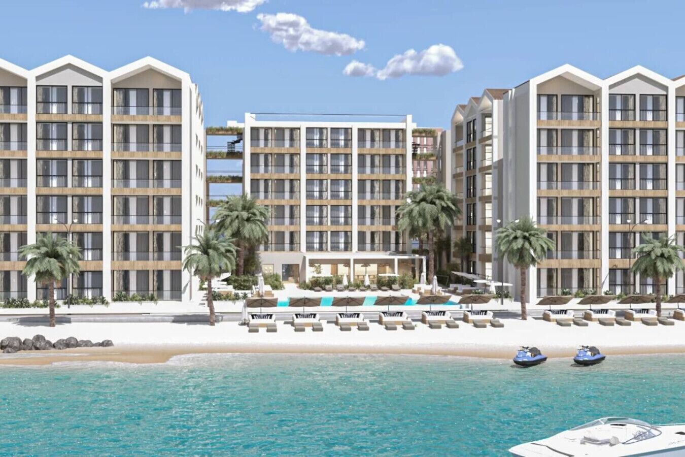 Un hotel frente a la playa con edificios de varios pisos, un área de piscina y vistas a la playa.