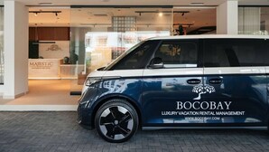 A luxury car parked in front of a building with a sign reading 'BOCOBAY LUXURY VACATION RENTAL MANAGEMENT.' - Majestic 2-Bed Pool Access Suite by Bocobay (Willemstad)