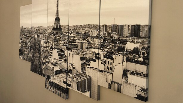 A panoramic cityscape with a prominent tower, likely a famous landmark, surrounded by dense urban buildings. - Luxury apartment line 14 IGR Paul Brousse Paris (Villejuif)