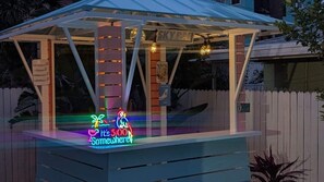 A covered outdoor bar area with a neon sign indicating a special offer. - Private Pool Retreat Near New Smyrna Beach (New Smyrna Beach)
