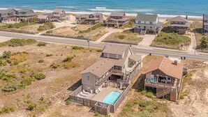 A coastal property with multiple buildings, a swimming pool, and a beach view. - JL #296 | East Of Eden - Semi-Oceanfront - Horizon Ocean View - Private Pool (Nags Head)