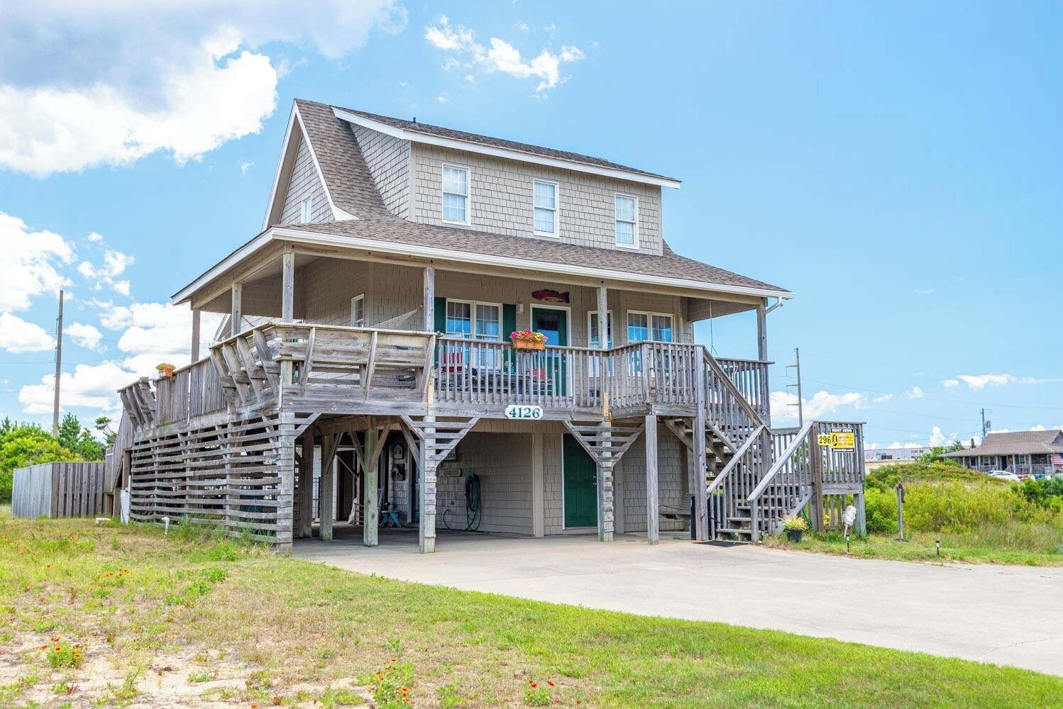 A two-story building with a balcony, a porch, and a visible number '4126'.