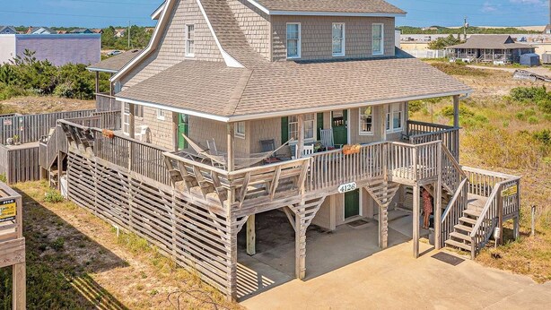 A two-story wooden house with a balcony, a porch, and a visible number '4126'. - JL #296 | East Of Eden - Semi-Oceanfront - Horizon Ocean View - Private Pool (Nags Head)