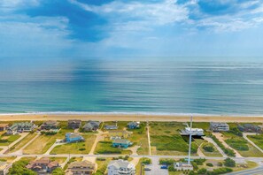 A coastal residential area with houses, a beach, and a clear sky. - JL #836 - The Happiest Hour - Close to Beach - Private Pool - SSCA Amenities (Southern Shores)
