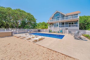 A two-story house with a swimming pool, lounge chairs, and a covered patio area. - JL #034 - Solitude House - Oceanside - Private Pool - Hot Tub (Southern Shores)