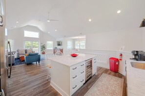 A spacious kitchen with a marble island, white cabinetry, and a red fire extinguisher. - JL #034 - Solitude House - Oceanside - Private Pool - Hot Tub (Southern Shores)