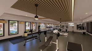 Ein modernes Fitnessstudio mit Laufbändern, Kraftgeräten und Bänken.