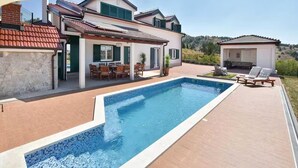 A poolside view of a house with a swimming pool, outdoor seating, and a small gazebo. - Seaview Family Villa With Heated Pool (Okrug)