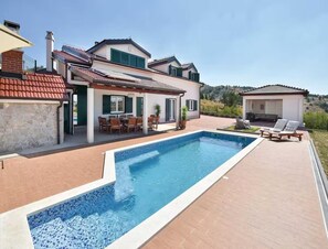 A poolside view of a house with a swimming pool, outdoor seating, and a small gazebo. - Seaview Family Villa With Heated Pool (Okrug)