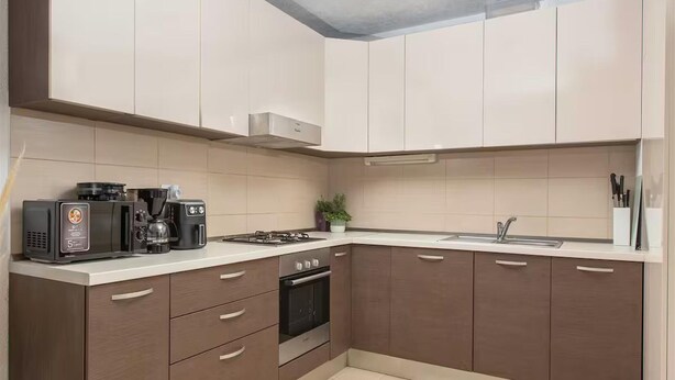 A modern kitchen with a microwave, coffee maker, stove, oven, and a sink. - Seaview Family Villa With Heated Pool (Okrug)