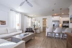 A modern living room with a sofa, coffee table, and chairs, a dining area with a table and chairs, and a kitchen with cabinets and appliances. - The Tanglewood, 3BR by Velvet Ditch Villas (Oxford)