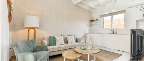 Comfort Apartment, Garden View | Living area | 50-inch Smart TV with digital channels