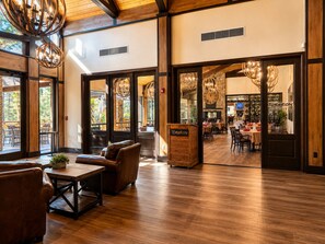 A restaurant interior with wooden flooring, leather seating, and large windows. - Escape the Arizona Heat + 2 King Suites + Bunk Room (Show Low)