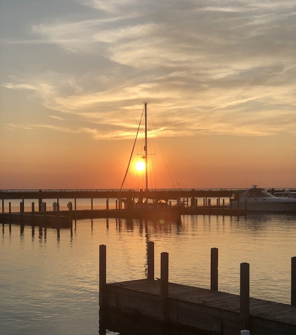 A pier extending into calm water with a sunset in the background. - The Cottage of Port Austin - Pet Friendly (Port Austin)