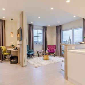 A modern living room with a sofa, armchair, and a coffee table. - Hotel Bad Rappenau (Bad Rappenau)