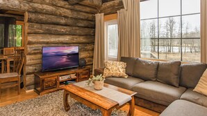 A log cabin interior with a television, sofa, and dining area. - Villa kaunisvirta by Interhome (Pyhtää)