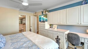 A bedroom with a bed, a desk, a chair, a television, and a wardrobe. - 2 Bedroom beach/pool view,37ft balcony, boat slip,6 month rental only, May-Oct. (Marco Island)