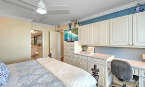 A bedroom with a bed, a desk, a chair, a television, and a wardrobe. - 2 Bedroom beach/pool view,37ft balcony, boat slip,6 month rental only, May-Oct. (Marco Island)