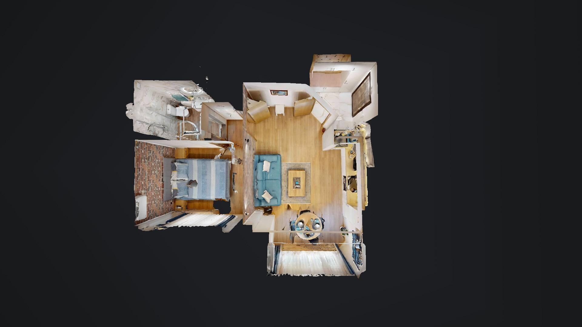 A compact RV layout with a kitchenette, a dining area, a living room with a sofa, and a small bathroom.