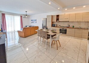 Eine moderne Wohnung mit Essbereich, Küche und Wohnraum.