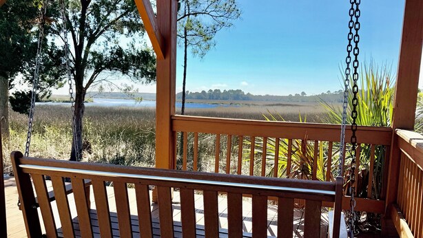 A wooden deck with a swing, a pergola, and a view of a natural landscape. - 3-bedroom townhome in gorgeous St. Marys with Pool, Boat Ramp and Riverviews (St. Marys)