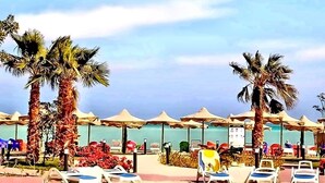 A beachside resort with palm trees, beach umbrellas, and lounge chairs. - Your perfect Red Sea getaway at Hurghada. (Hurghada)