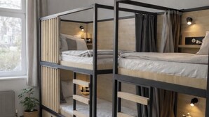 A room with bunk beds, a potted plant, a rug, and a window with curtains. - Mixed Dorm 8 - 1 Bed (Berlin Sleep Club) (Berlin)