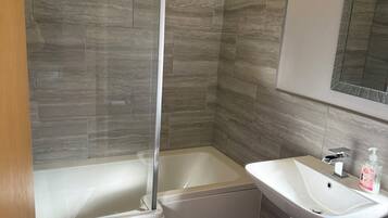 Shower, hair dryer, soap, toilet paper