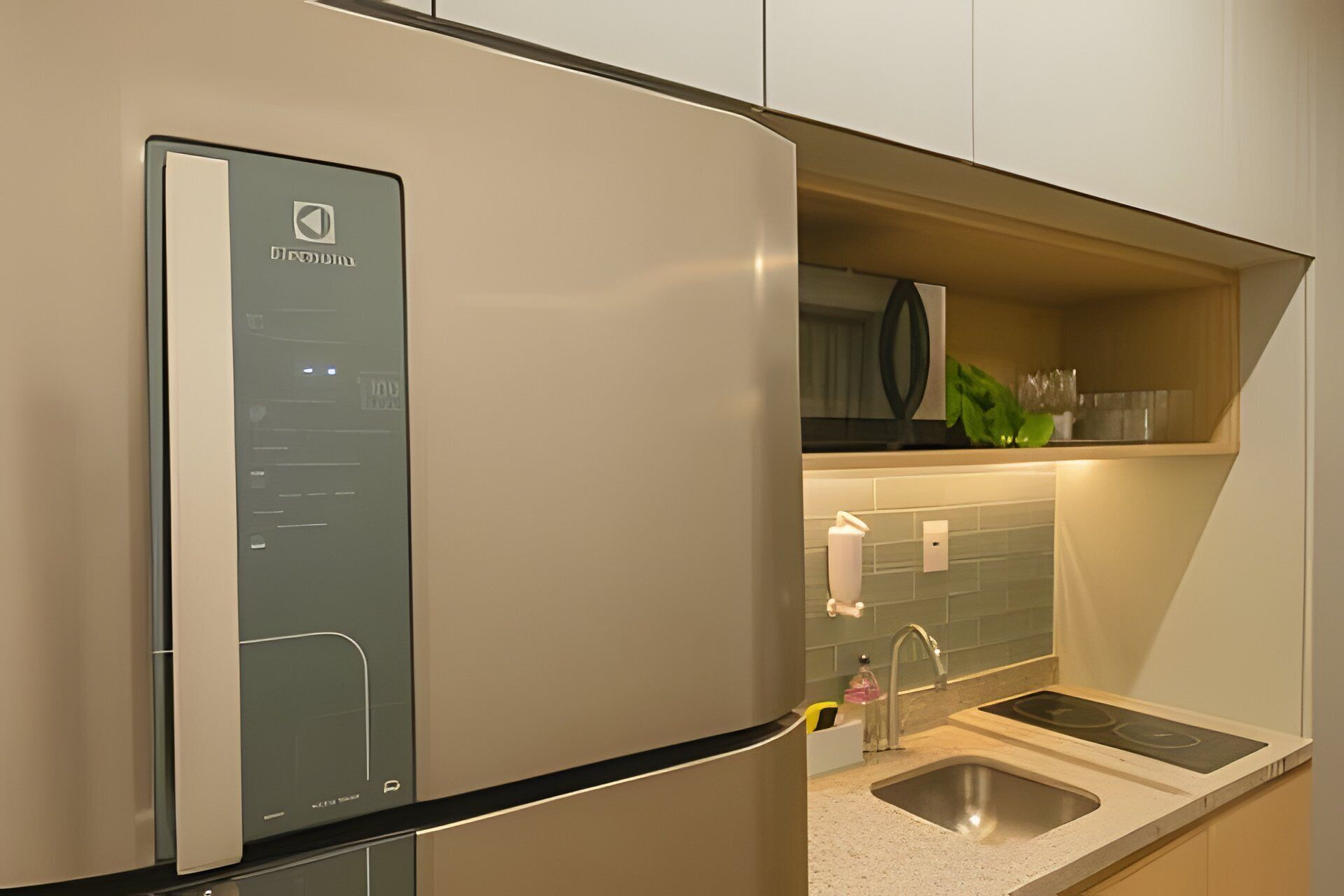 A modern kitchen with a built-in refrigerator, a microwave, and a sink.