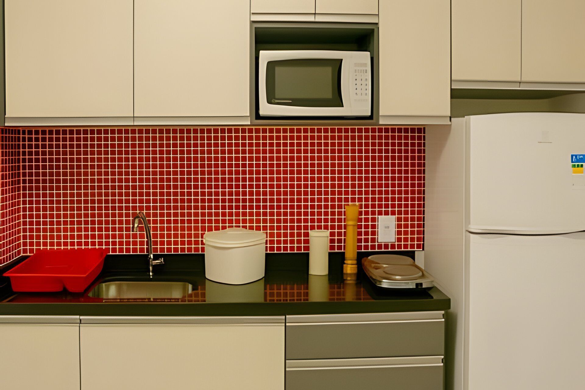 A kitchen with a microwave, sink, and refrigerator.