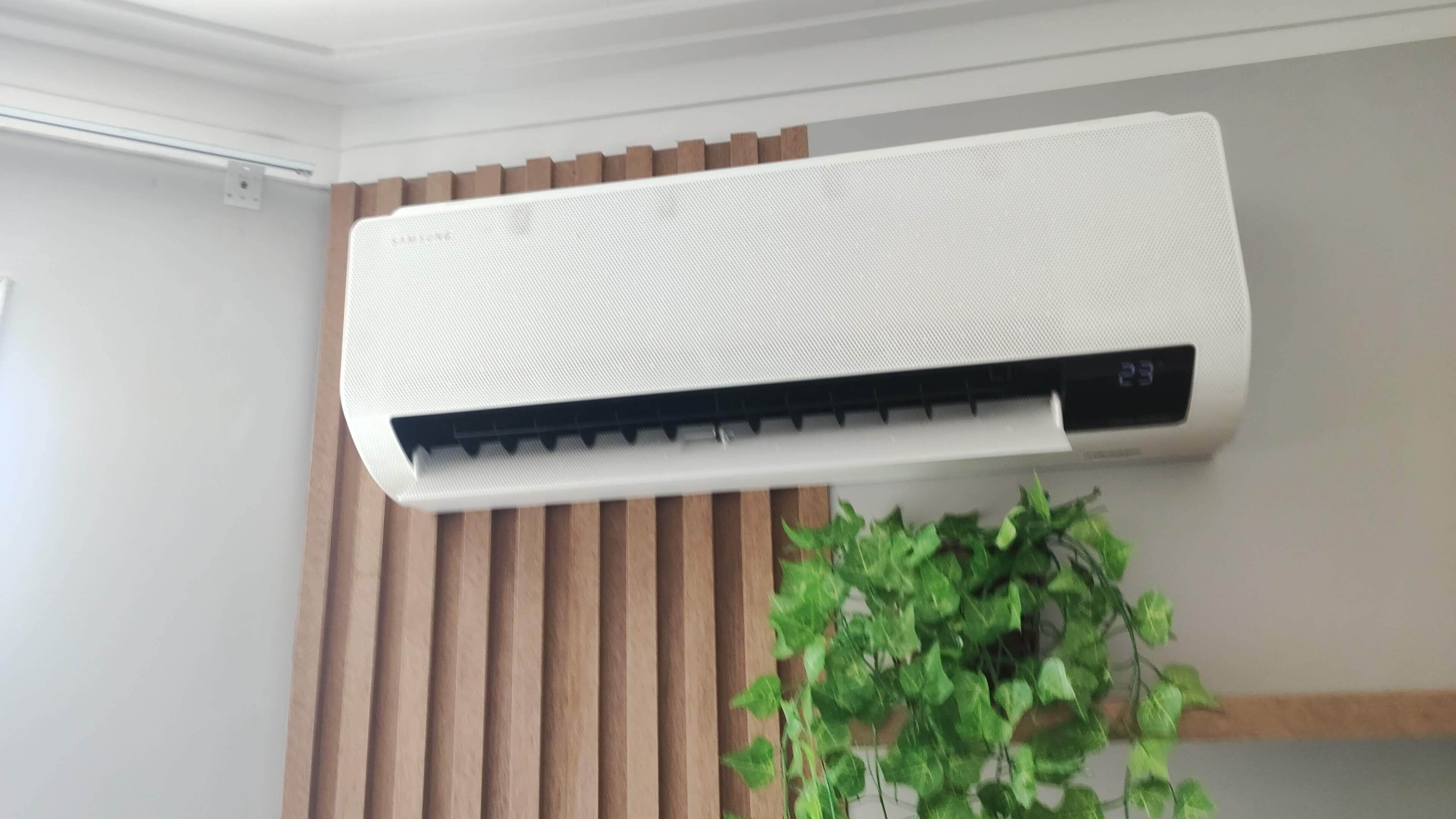 A white wall-mounted air conditioner with a digital display.