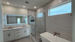 Shower, hair dryer, towels, shampoo