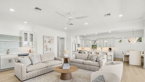 A spacious living area with a large round coffee table, two sofas, and a ceiling fan. - Salt House · 2026 Luxury · 6 King Suites 2 Masters (Fort Myers Beach)