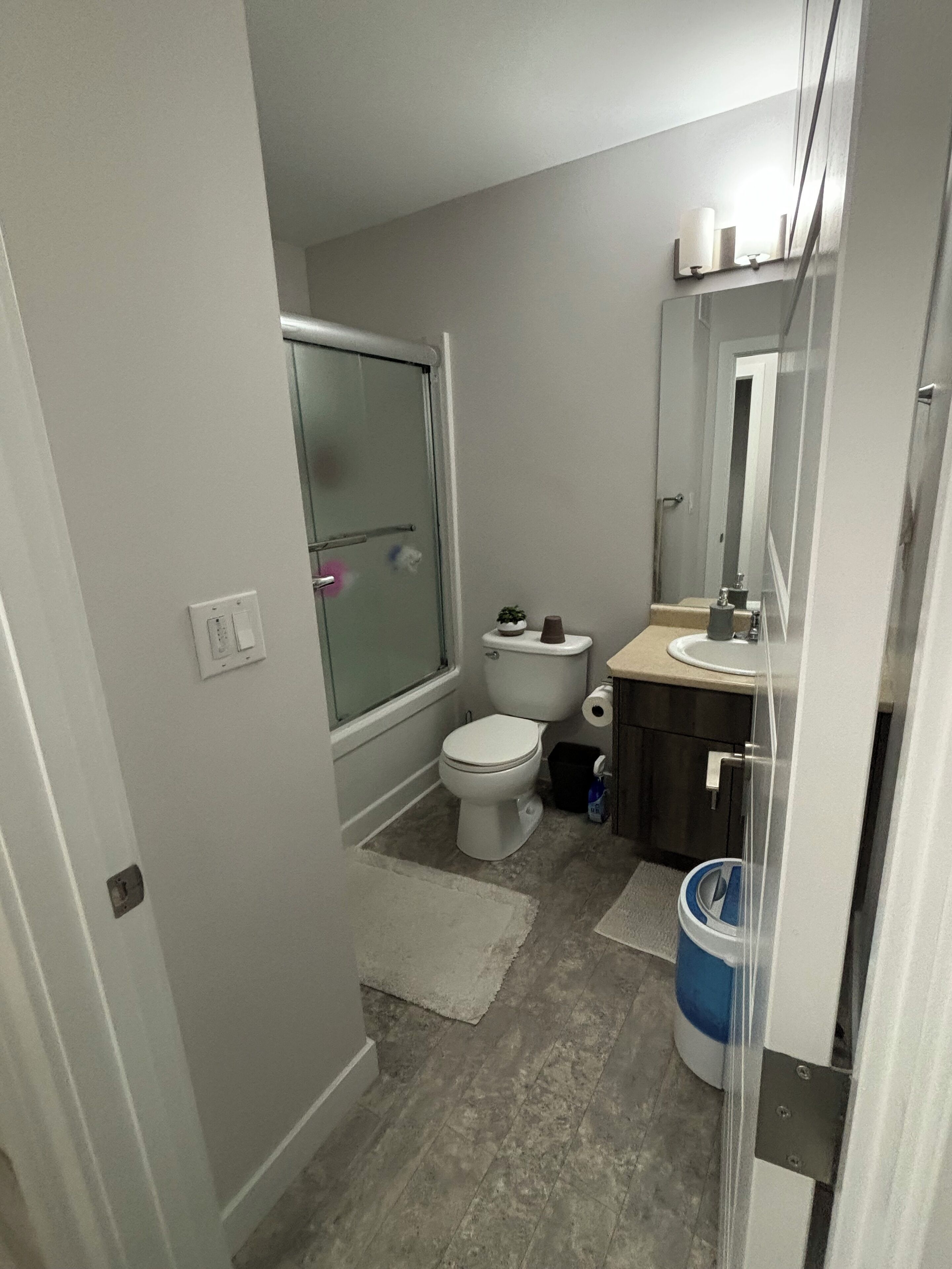 A bathroom with a toilet, sink, and shower.
