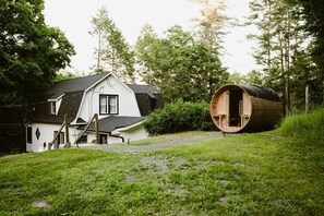 A house with a sloped roof and a large cylindrical structure resembling a barrel. - Sauna, King Suite, Fire Pit | Foliage, 2 Hrs NYC (Eldred)