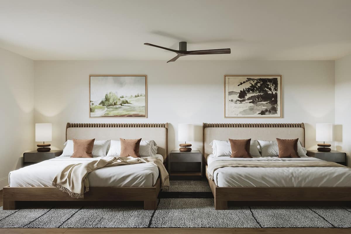A double bed room with a ceiling fan, two bedside tables, and two wall-mounted lamps.