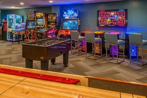 A gaming area with foosball tables, various arcade games, and bar seating. - Grand Colorado on peak 8, 1-bedroom Breckendrige, condo in charming Breckenridge (Breckenridge)