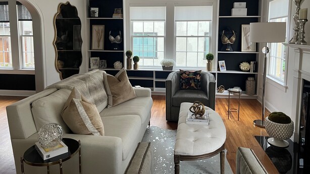 A living room with a chandelier, a sofa, a coffee table, and a fireplace. - Eclectic Clarksville Austin Sauna Cold Plunge Fitness.  Walk to ACL is 1.4 miles (Austin)