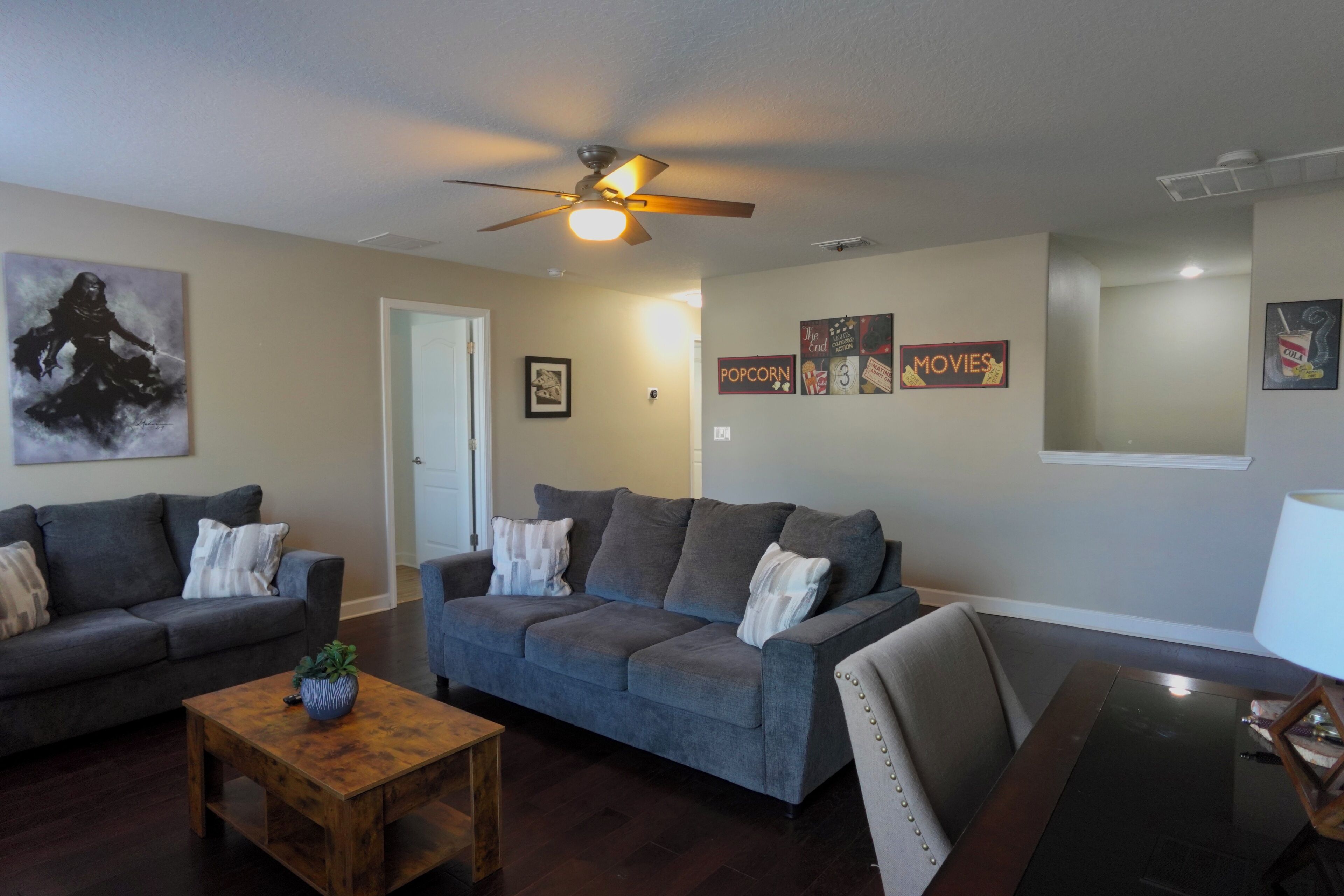 A living room with two sofas, a coffee table, and a dining table.