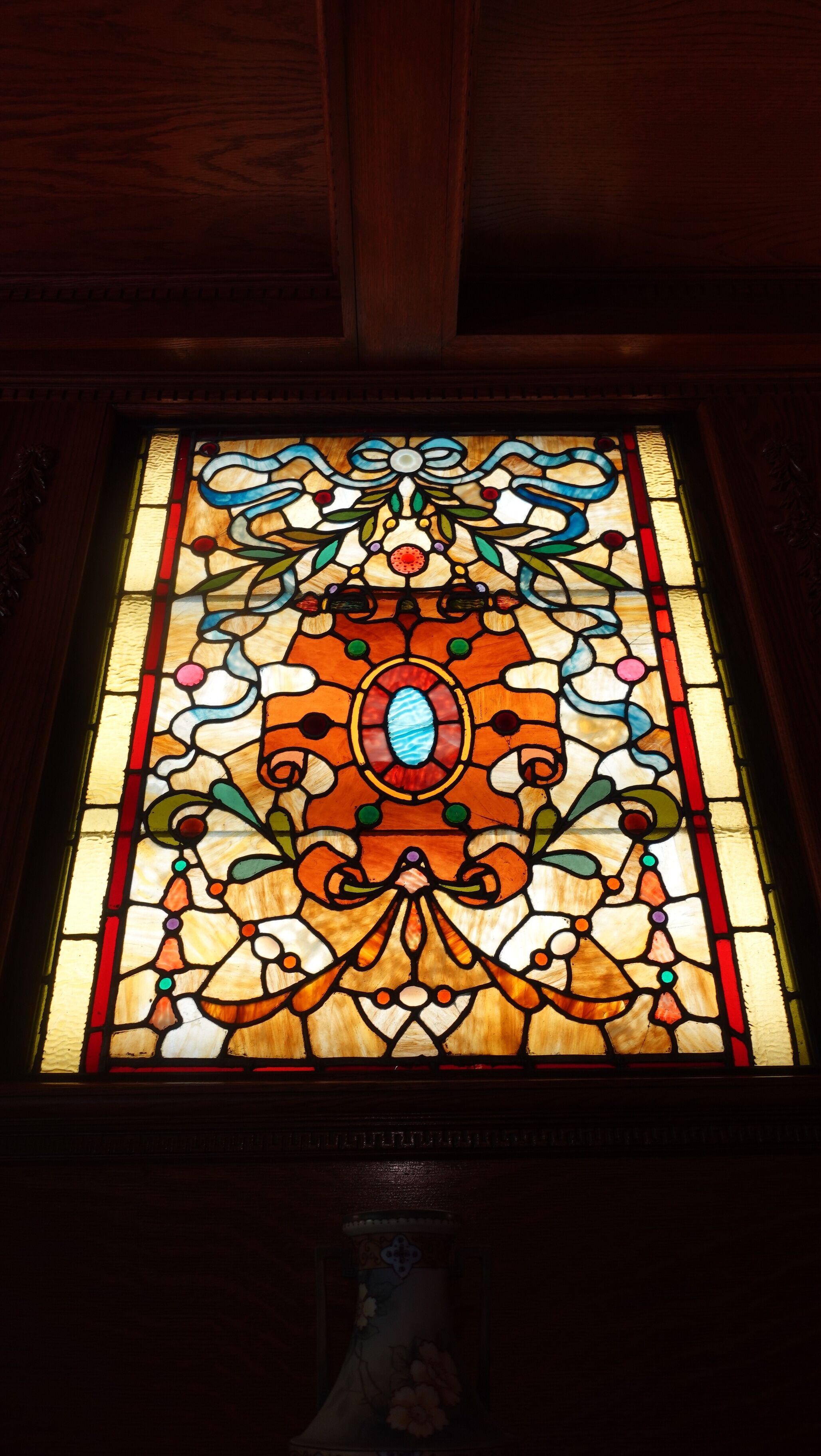 A stained glass window with a floral pattern.