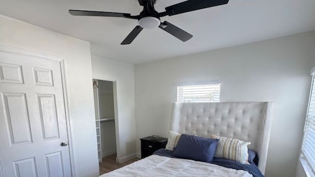 A bedroom with a bed, a ceiling fan, a window, and a door. - Walk to Downtown Delray and beach.   Huge fenced-in yard for dog (Delray Beach)