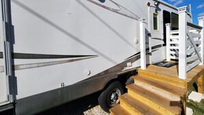 A white RV with a ramp leading to a wooden deck. - 12 min to the Everglades Nat. Park & near FL Keys! Cozy RV in Redland w/laundry (Homestead)